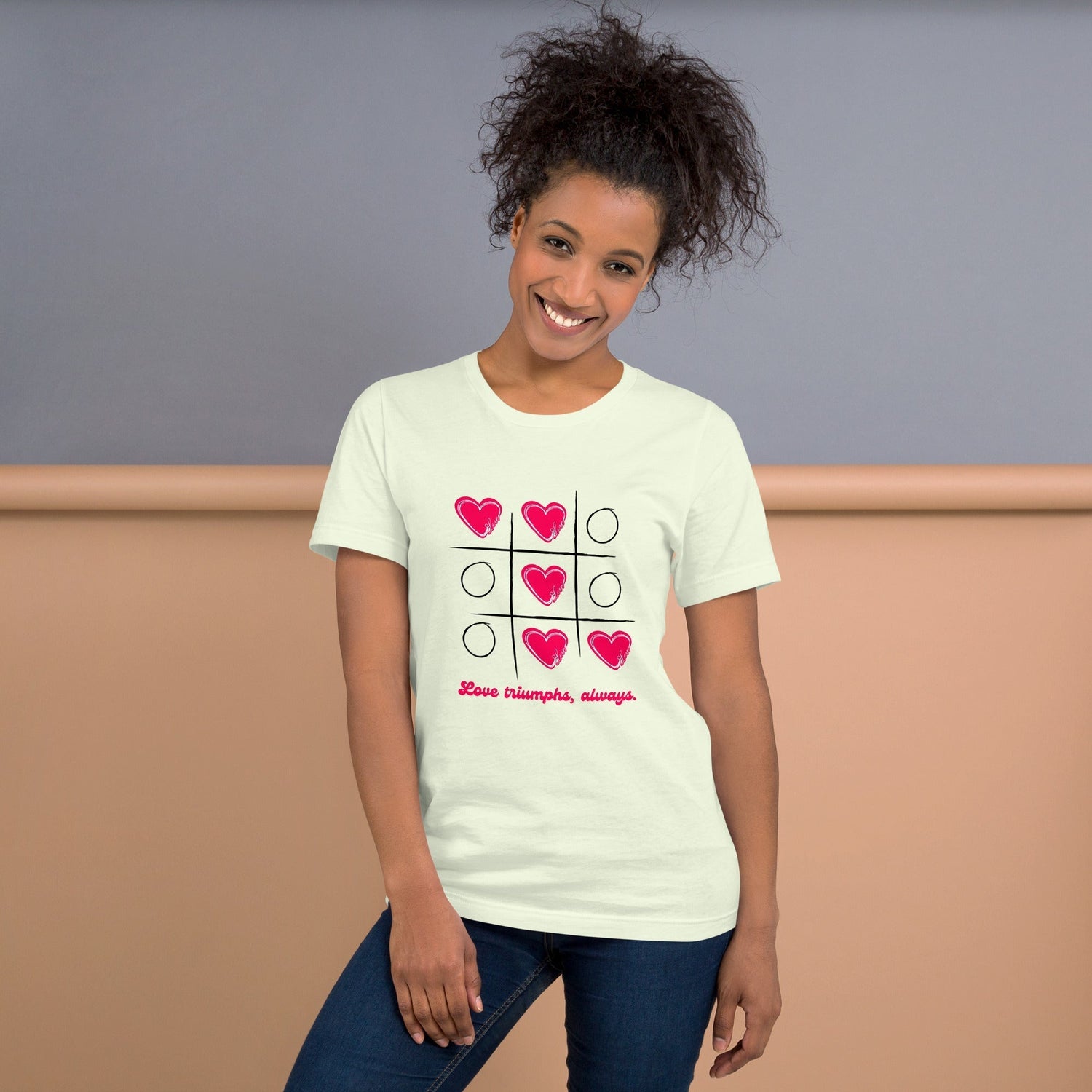 Lady wearing Tic Tac Toe Hearts T-shirt. Blue and Pink Backgorund